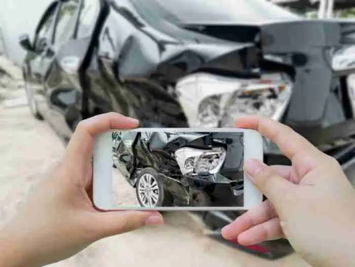 Phone taking photo of car damage